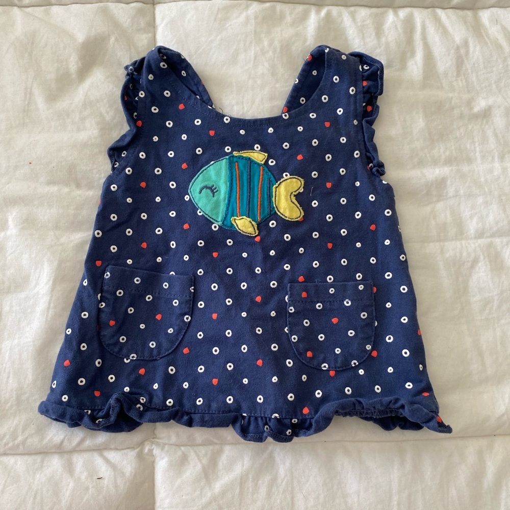 Sweetest tank w/ open back and darling button detail.